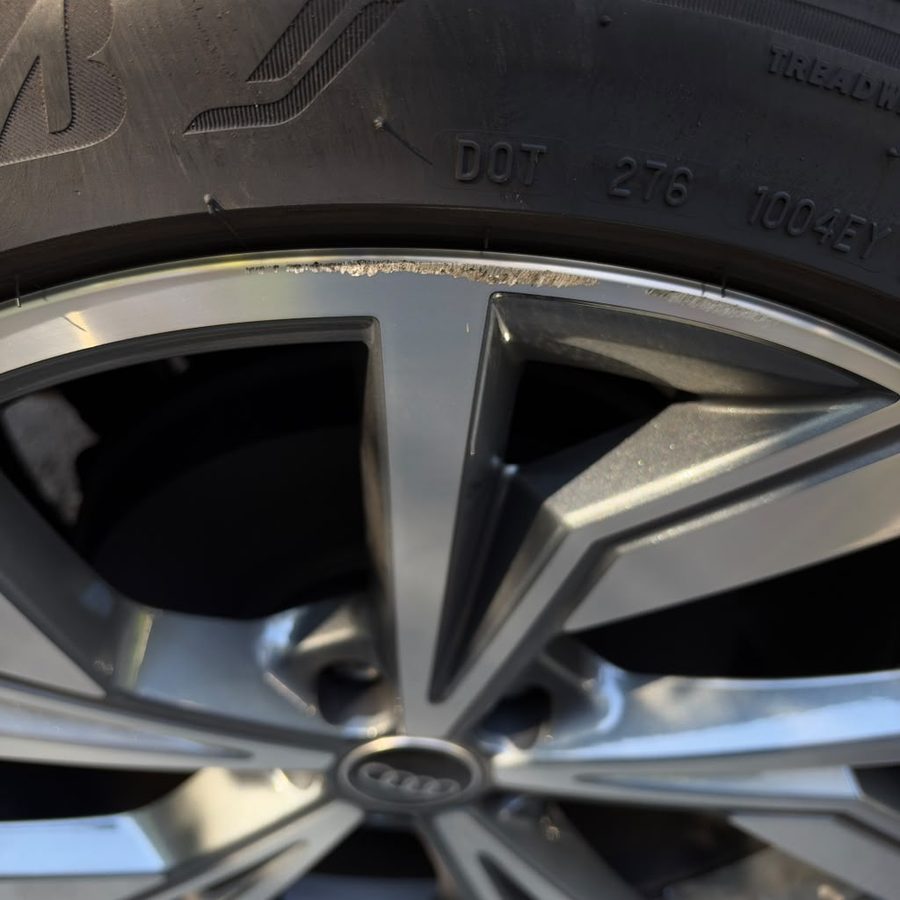 Audi wheel with curb rash before repair